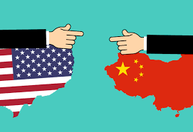 American flag shaped in the American landmass on the left and Chinese flag shaped in the Chinese landmass on the right with two arms pointing towards each other.