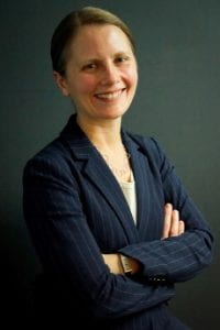 A headshot of the co-director of the NRC (female) in formal attire.