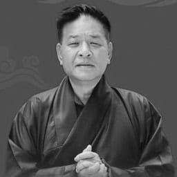 A black and white headshot of Sikyong Penpa Tsering